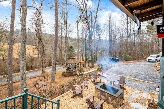 view of yard featuring a gazebo and a fire pit