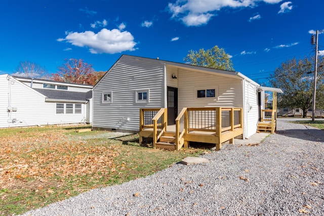 rear view of house with a wooden deck