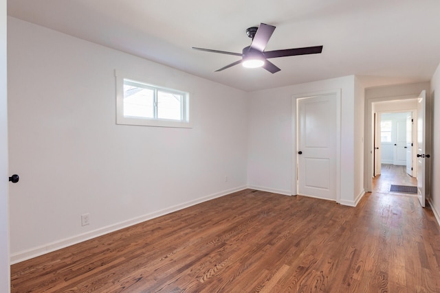 spare room featuring ceiling fan and dark hardwood / wood-style floors