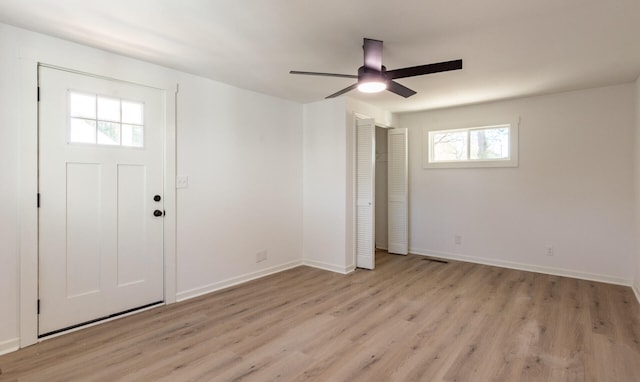 entrance foyer with ceiling fan, a healthy amount of sunlight, and light wood-type flooring