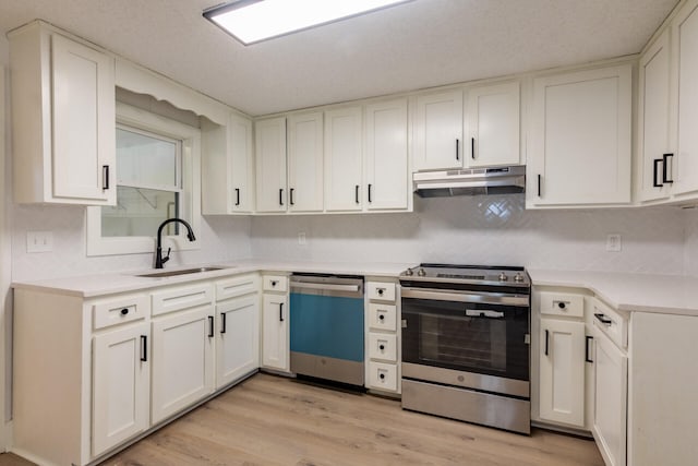 kitchen featuring white cabinets, appliances with stainless steel finishes, sink, and light hardwood / wood-style floors