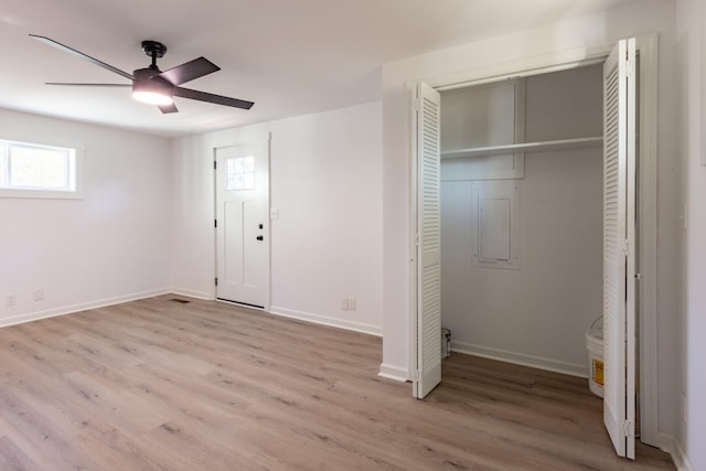 unfurnished bedroom with ceiling fan and light wood-type flooring