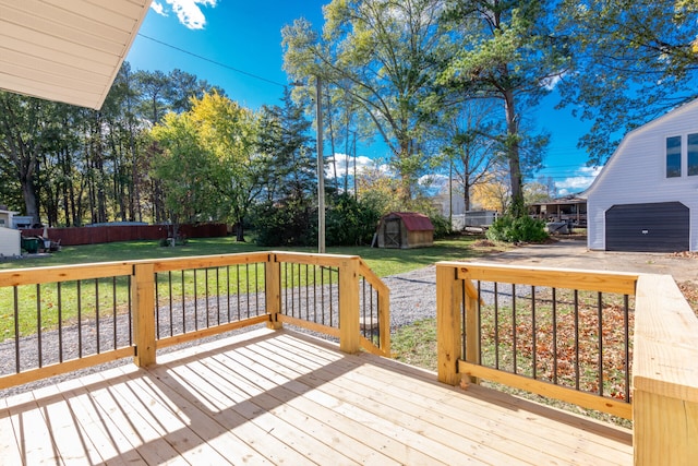 wooden deck featuring a shed and a yard