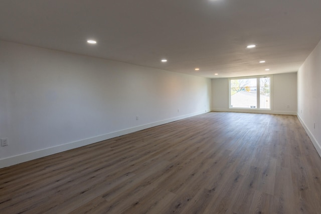 unfurnished room with dark wood-type flooring