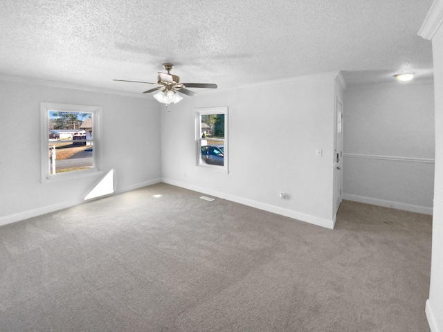 empty room featuring ceiling fan, crown molding, carpet floors, and a textured ceiling