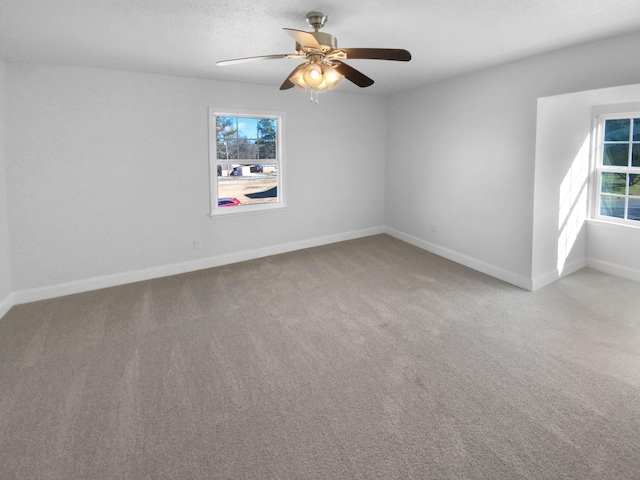 spare room featuring ceiling fan and light colored carpet