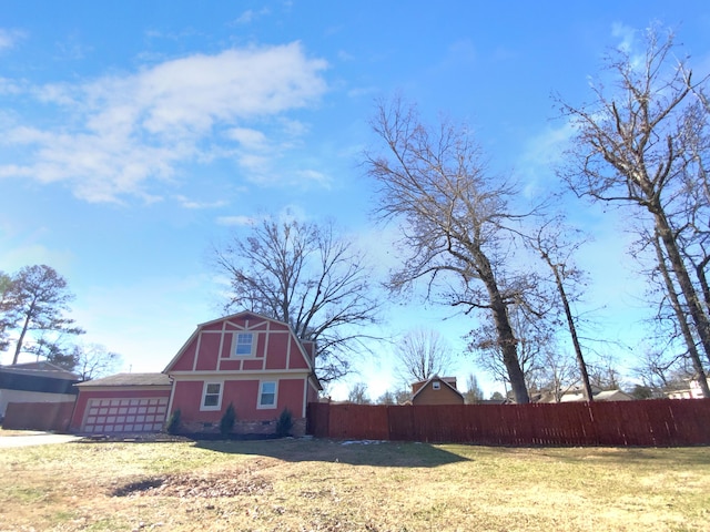 view of side of property with a garage and a yard