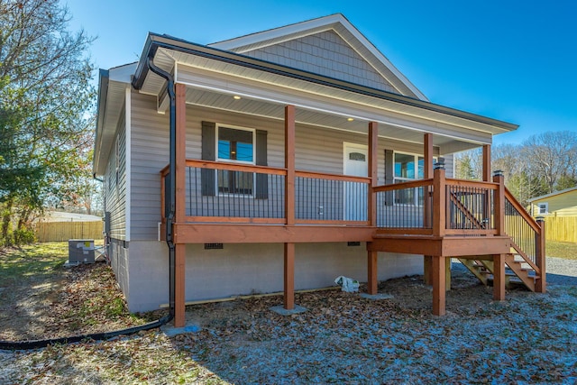 rear view of house featuring central air condition unit and a porch