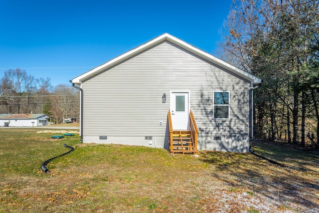 back of house with a lawn