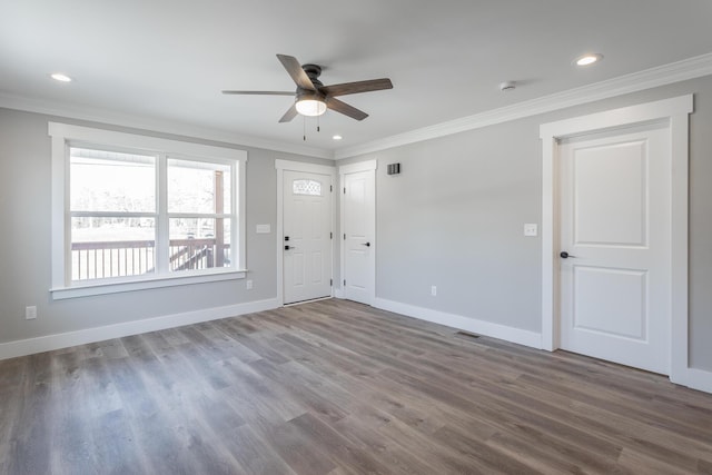 empty room featuring ceiling fan, crown molding, and hardwood / wood-style floors