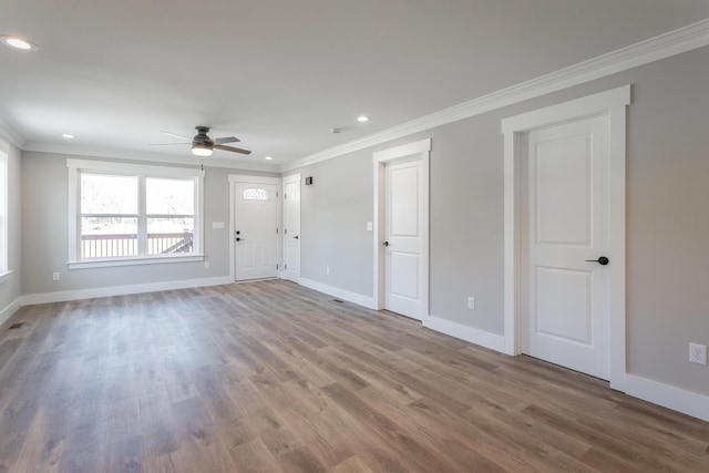 unfurnished room featuring ceiling fan, hardwood / wood-style floors, and ornamental molding