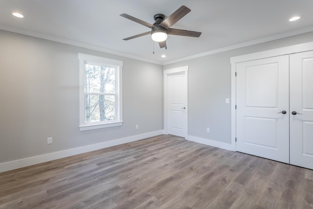 unfurnished bedroom featuring ceiling fan, light hardwood / wood-style floors, a closet, and crown molding