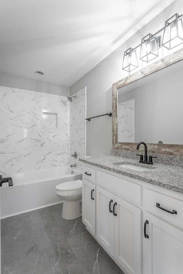 full bathroom featuring toilet, tiled shower / bath, and vanity