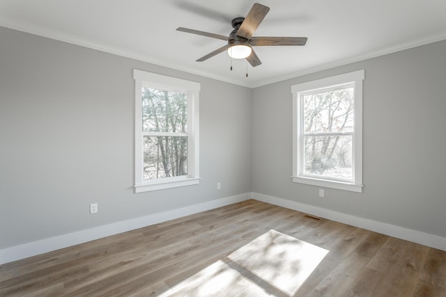 spare room featuring ceiling fan, crown molding, and light hardwood / wood-style flooring