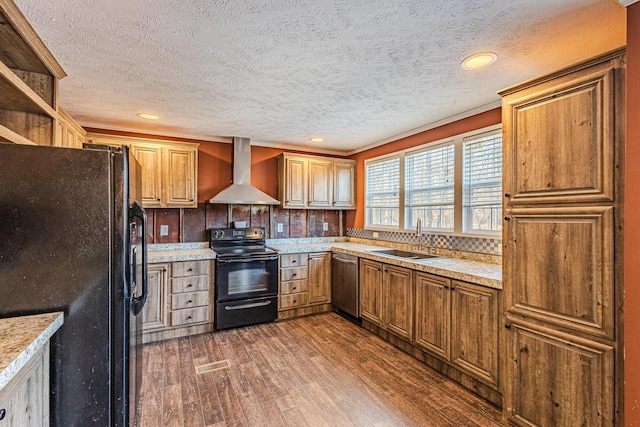 kitchen with sink, black appliances, dark hardwood / wood-style flooring, wall chimney range hood, and backsplash