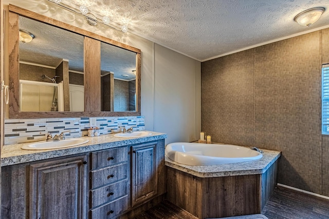 bathroom featuring crown molding, a textured ceiling, vanity, independent shower and bath, and backsplash