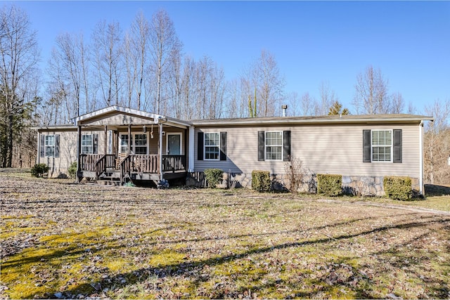 view of front of house with covered porch and a front yard