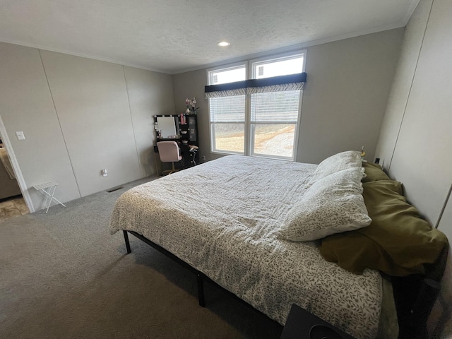 carpeted bedroom featuring a textured ceiling and ornamental molding