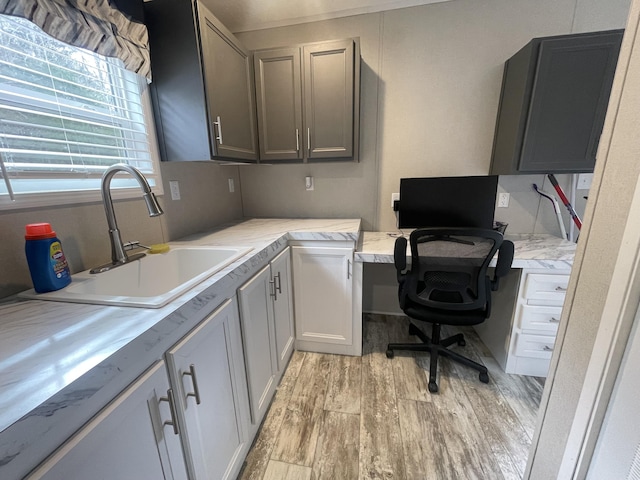 office space featuring light hardwood / wood-style floors and sink