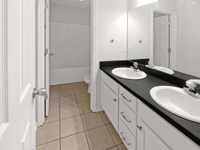 bathroom featuring a textured ceiling, tile patterned floors, vanity, and toilet