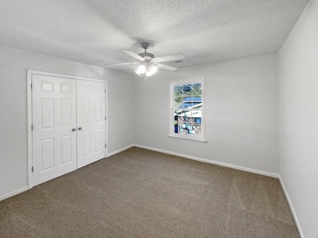 unfurnished bedroom with ceiling fan, carpet, a closet, and a textured ceiling