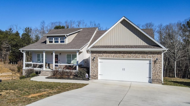 craftsman-style home featuring a porch, a garage, and a front lawn