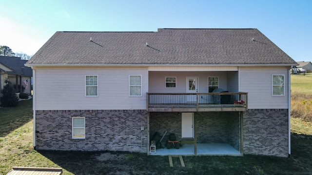 back of property featuring a lawn and a patio