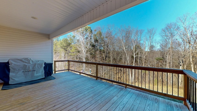 wooden terrace with a grill