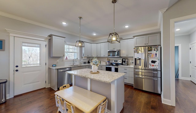 kitchen with hanging light fixtures, sink, gray cabinetry, a kitchen island, and stainless steel appliances