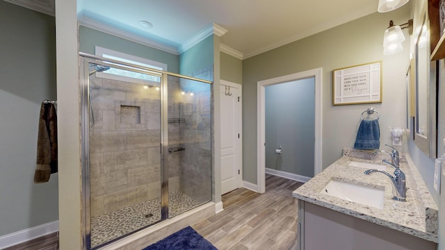 bathroom with hardwood / wood-style floors, vanity, an enclosed shower, and ornamental molding