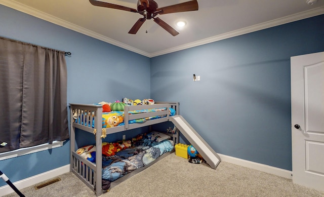 carpeted bedroom with ceiling fan and ornamental molding