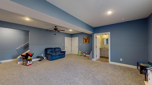 recreation room featuring light colored carpet and ceiling fan