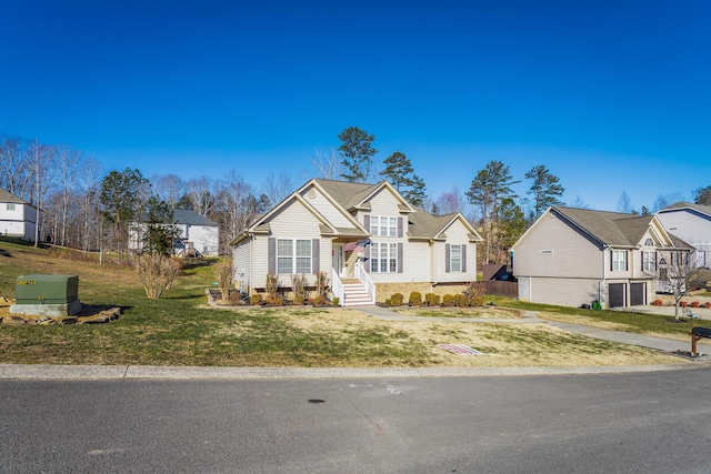 view of front of home with a garage and a front lawn