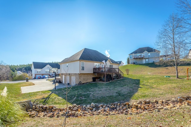 exterior space with a garage, a deck, and a yard