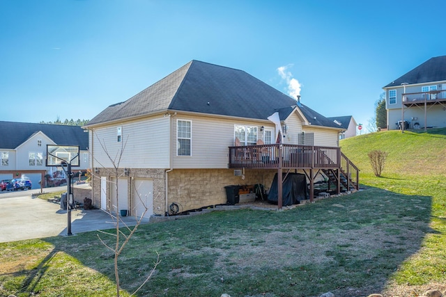 back of property with a garage, a wooden deck, and a yard