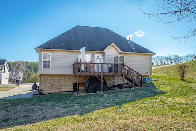 back of property featuring central AC, a wooden deck, and a yard