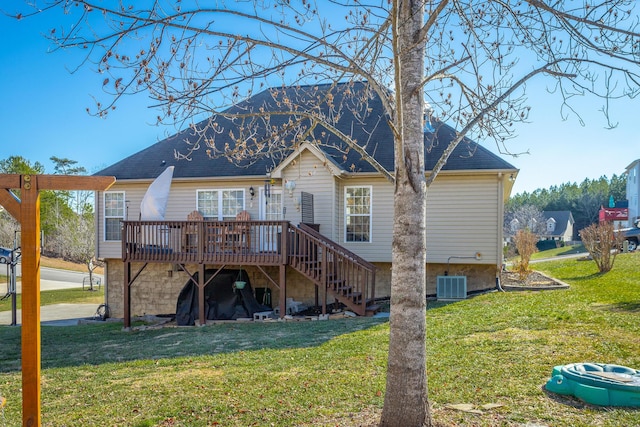 rear view of property with a wooden deck, a lawn, and central air condition unit