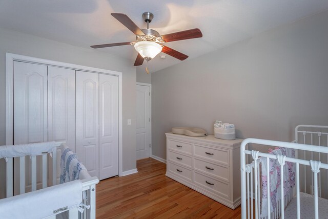 bedroom featuring ceiling fan, a closet, and light hardwood / wood-style flooring