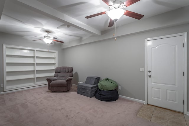 living area featuring light carpet, ceiling fan, and beamed ceiling