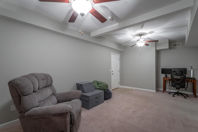 sitting room with ceiling fan, light carpet, and beamed ceiling