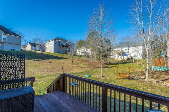 wooden deck featuring a lawn