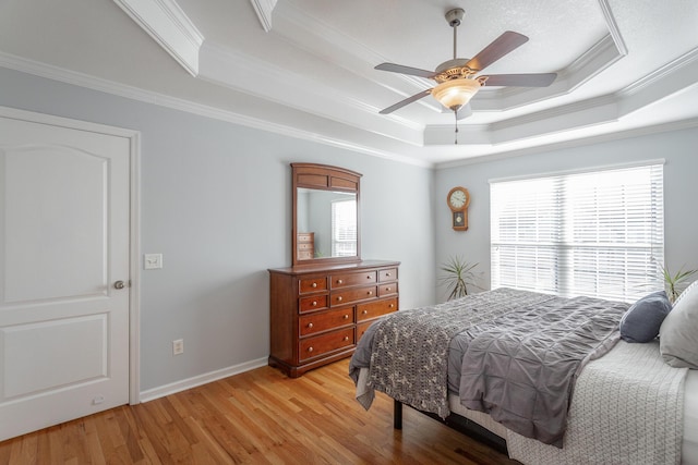 bedroom with a raised ceiling, ceiling fan, and ornamental molding