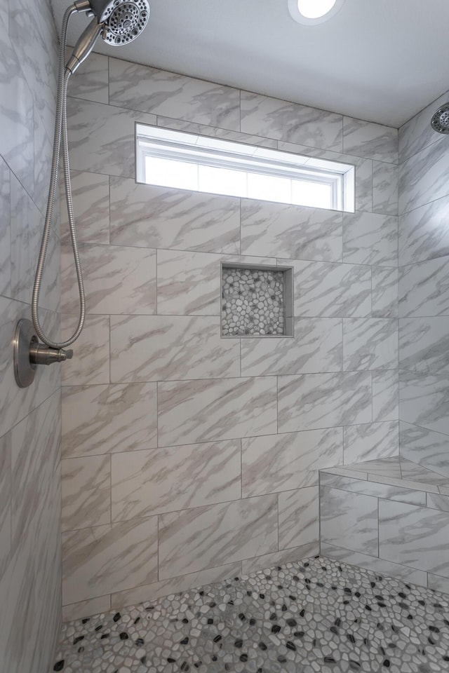 bathroom with tiled shower