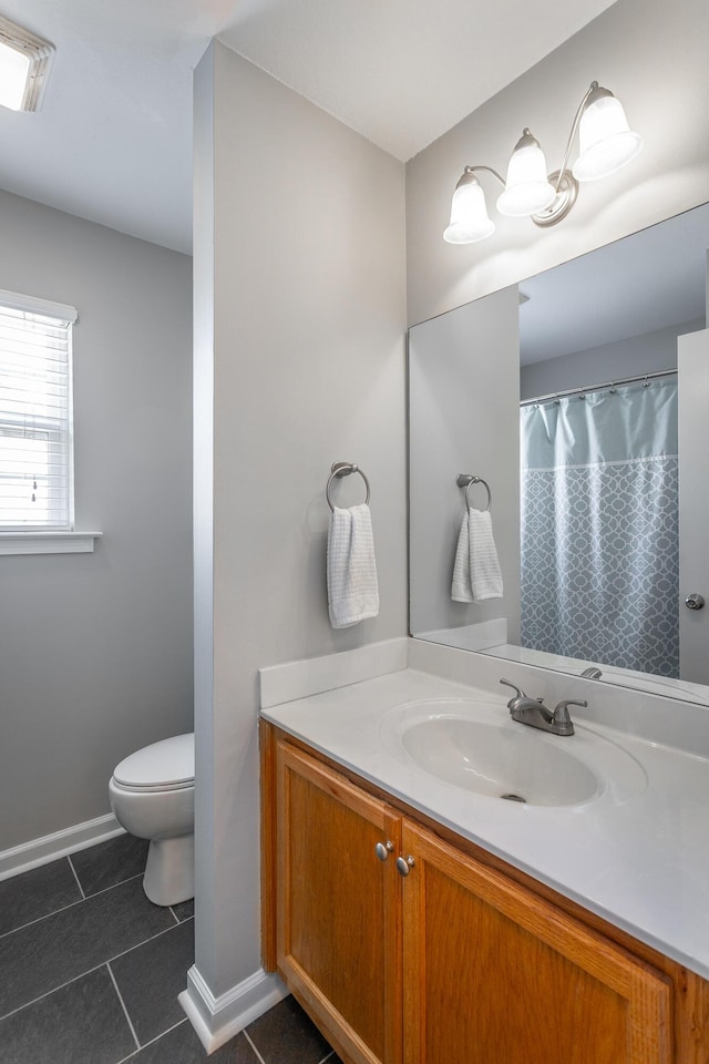 bathroom featuring toilet, tile patterned flooring, and vanity