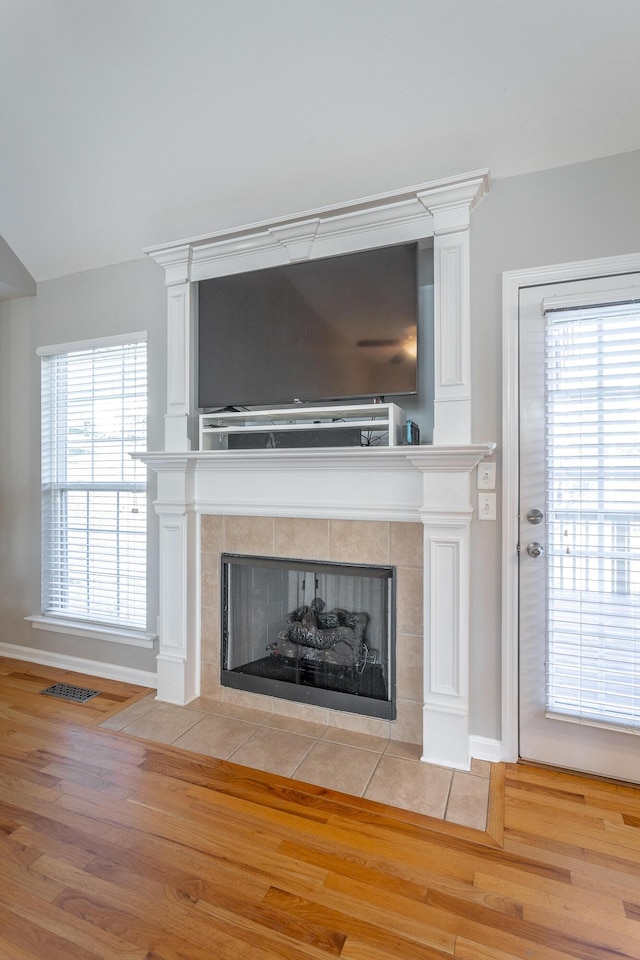 interior details with wood-type flooring and a fireplace