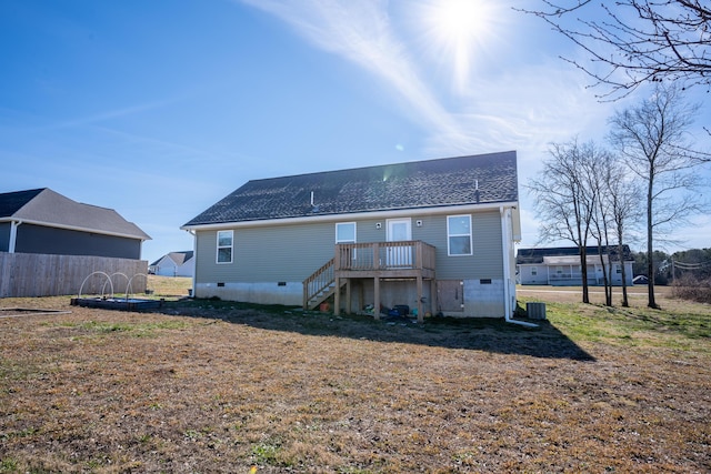 back of property featuring a wooden deck, a yard, and central air condition unit