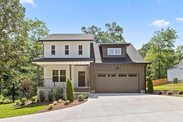 view of front facade featuring covered porch and a garage