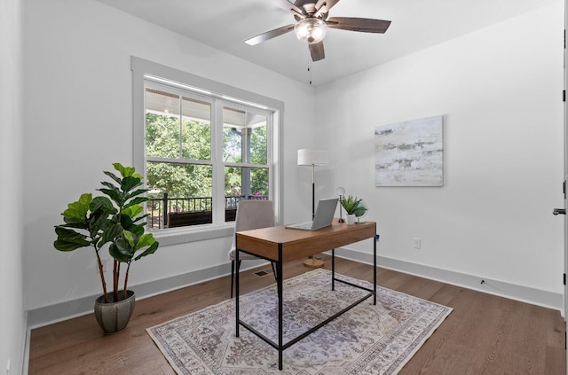 office space featuring ceiling fan and dark hardwood / wood-style flooring