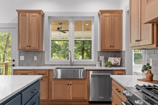 kitchen with decorative backsplash, sink, light stone counters, and appliances with stainless steel finishes