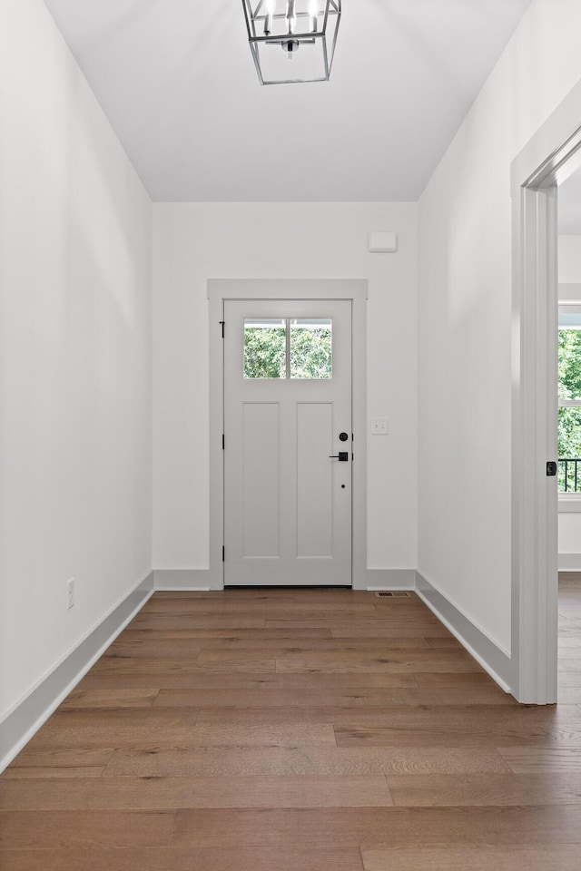 foyer featuring an inviting chandelier and light hardwood / wood-style floors